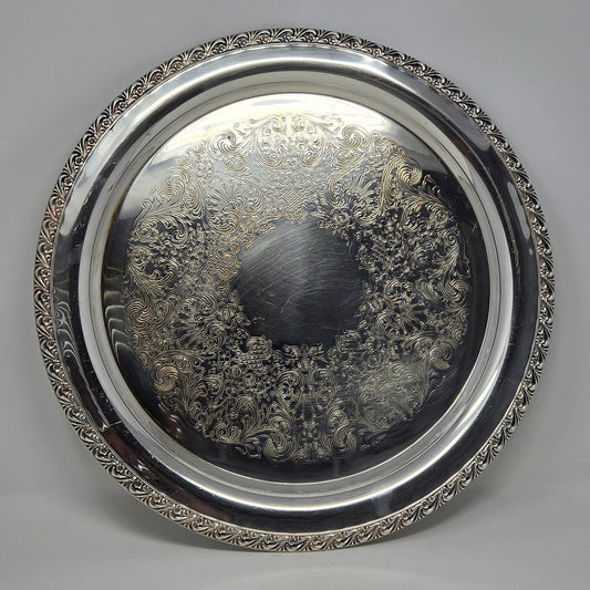 Vintage Wm Rogers ISC, Floral Pattern 772A round silverplated tray with an ornate embossed border.