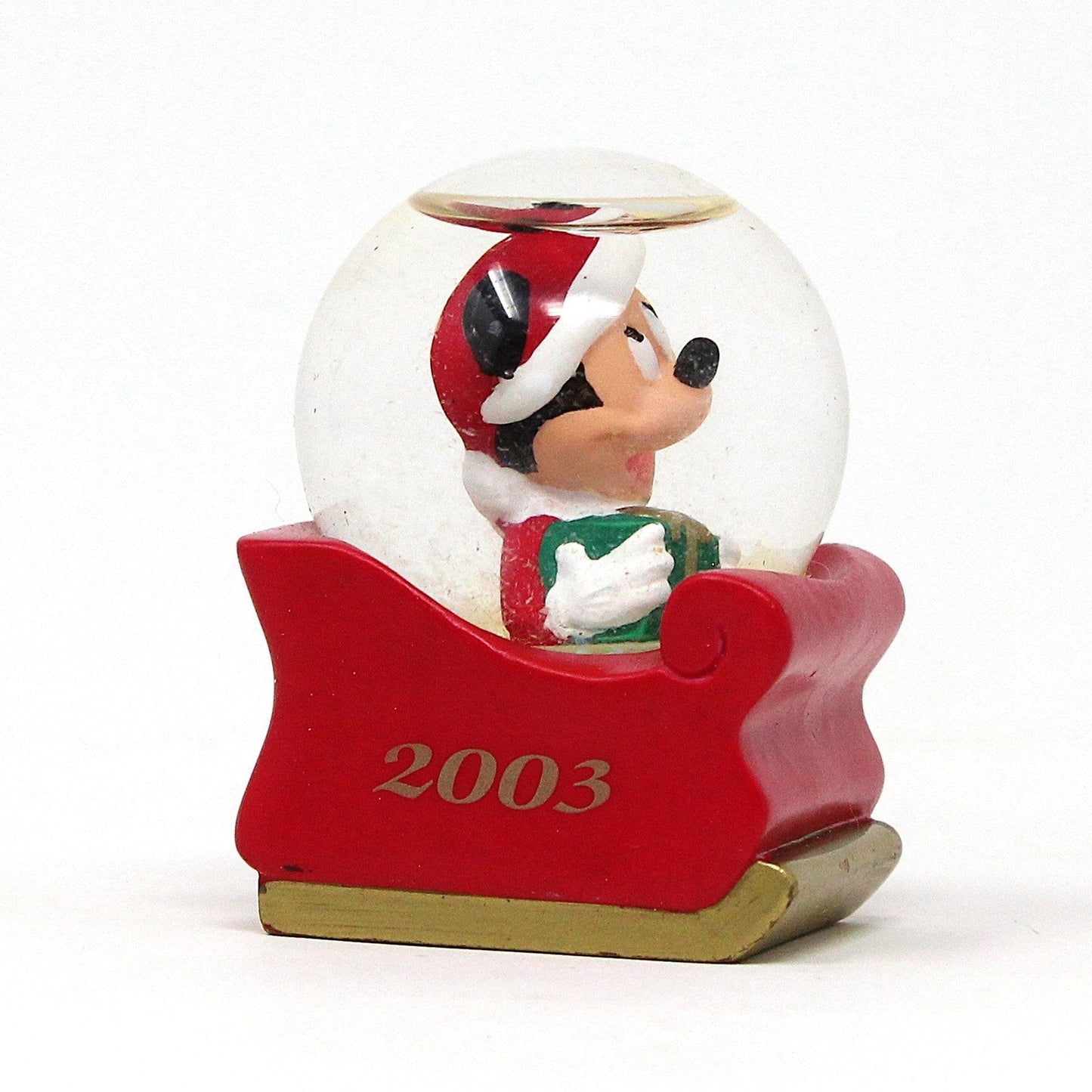 A mini Christmas snow globe featuring Mickey Mouse in a red sleigh with '2003' dated on one side, exclusive for JC Penney.