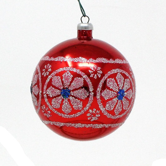 A vintage Yuletide brand Christmas ornament featuring a red, white, and blue ball with stenciled white glitter, unbreakable plastic, and a silver cap at the top.