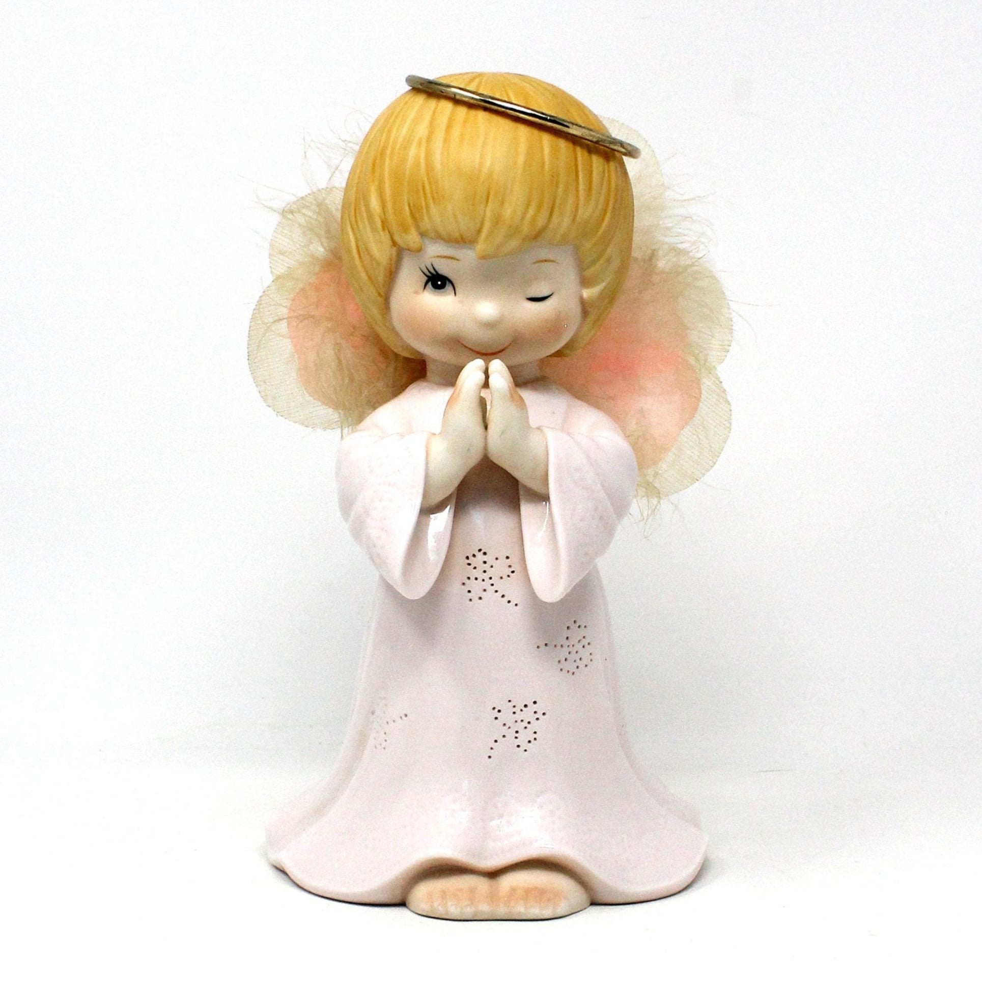A vintage porcelain fiber optic light up angel figurine in pink and white, with wings and a halo, praying, (does not light up).