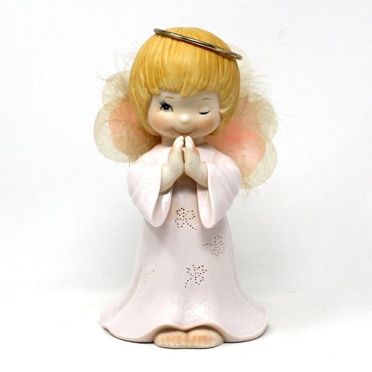 A vintage porcelain fiber optic light up angel figurine in pink and white, with wings and a halo, praying, (does not light up).