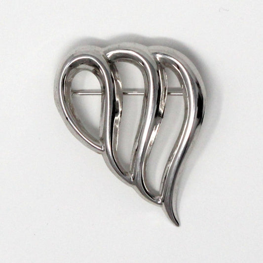 A sterling silver brooch in the shape of an abstract open heart with three wavy loops, signed Beau Sterling.
