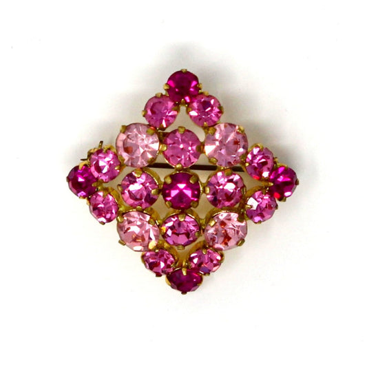 A square-shaped vintage brooch with a cluster of pink Austrian crystals in shades of hot pink, pink, and pastel pink, all prong set.