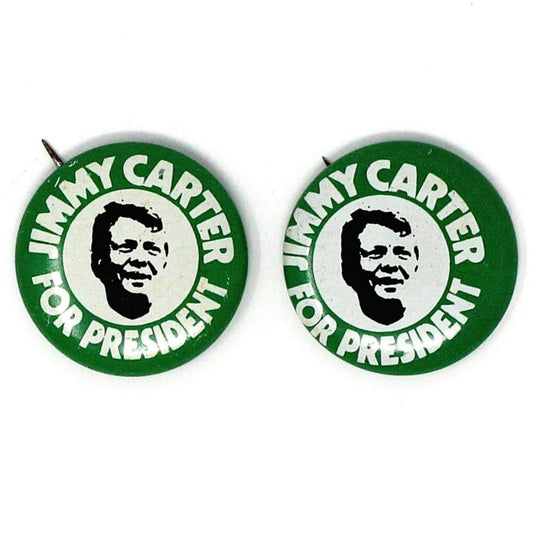 A vintage pinback button from the 1976 Jimmy Carter presidential campaign, featuring a green background with the text 'Jimmy Carter for President' and an illustration of Jimmy Carter's face.