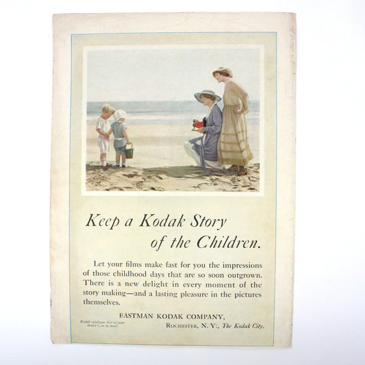 A vintage advertisement page featuring an illustration of a mother and two children at the beach, with the text 'Keep a Kodak Story of the Children.'.