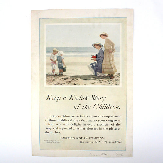 Antique Eastman Kodak Company advertisement from 1916, featuring an illustration of a mother and children at the beach, with the tagline 'Keep a Kodak Story of the Children.'.