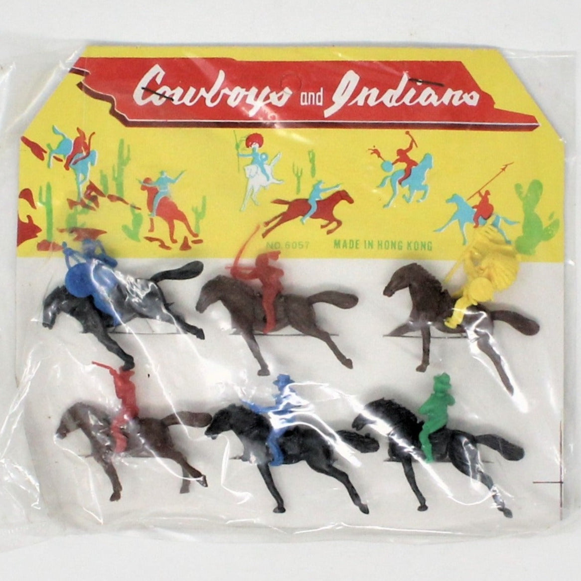 Vintage set of plastic toy figures depicting Western cowboys and Indians on horseback, in original pkg, with a colorful cardboard backing.
