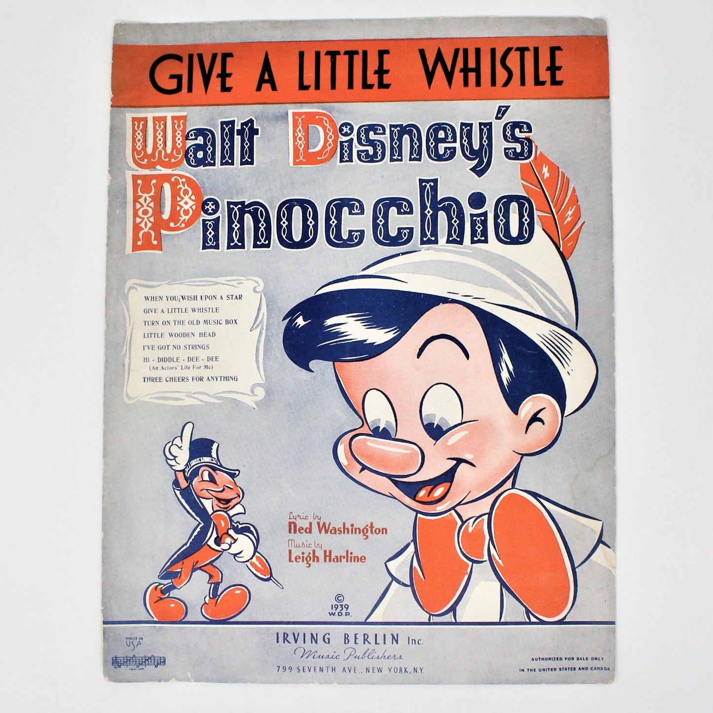 Vintage sheet music for Disney's Pinocchio, 'Give a Little Whistle' with an illustration of Pinocchio smiling and a small image of Jiminy Cricket