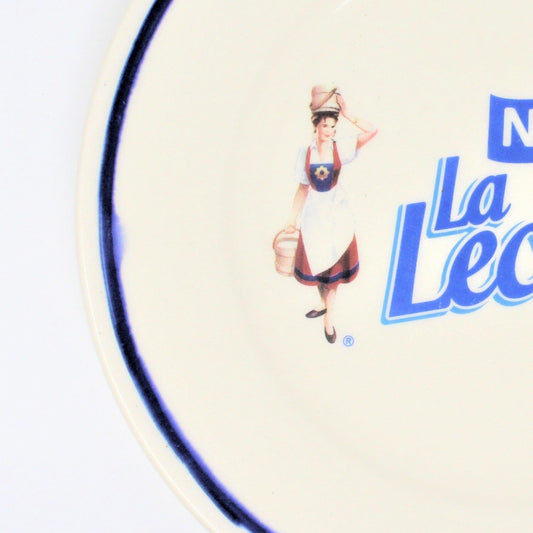 La Lechera logo with a character holding a basket.