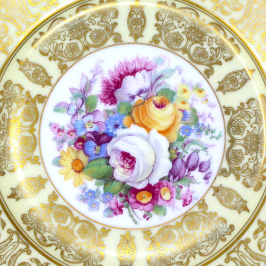 Close up view of floral center medallion on antique dessert plate set