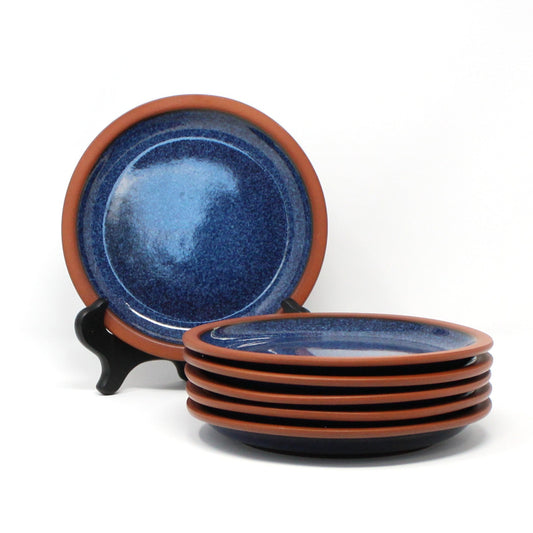 A set of six vintage terracotta and indigo blue ceramic appetizer plates with a rustic design. Henry Watson Pottery, England