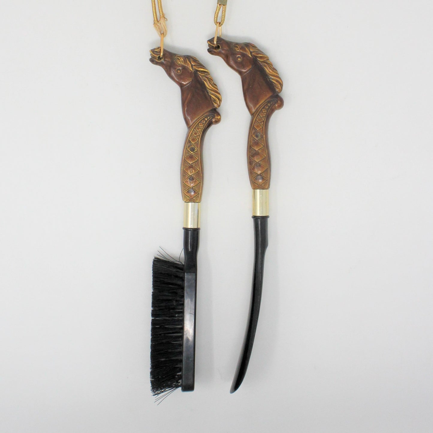 A vintage equestrian shoe horn and clothes brush set with horse head handles. Shoe Accessories, Household Organization. Decorative