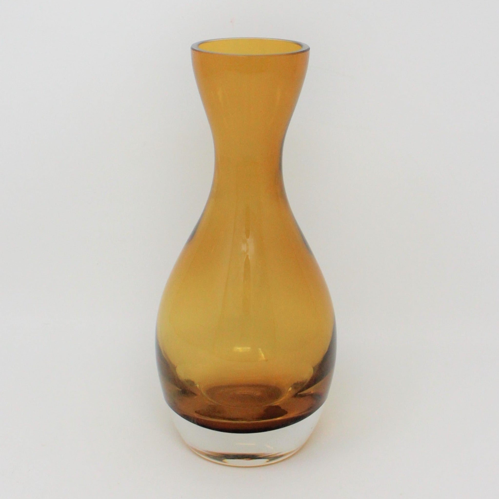 A conical blown glass vase with a topaz/amber color and a clear heavy bottom, Poland.
