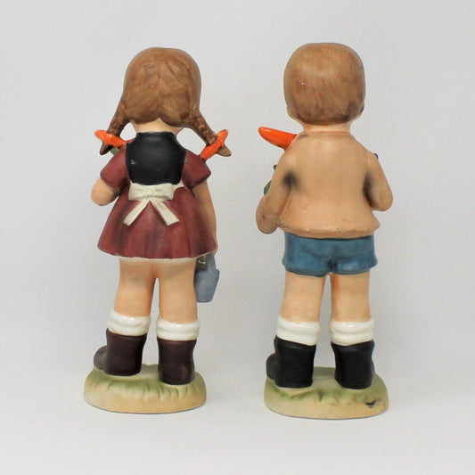 back view of girl & boy figurines gardening