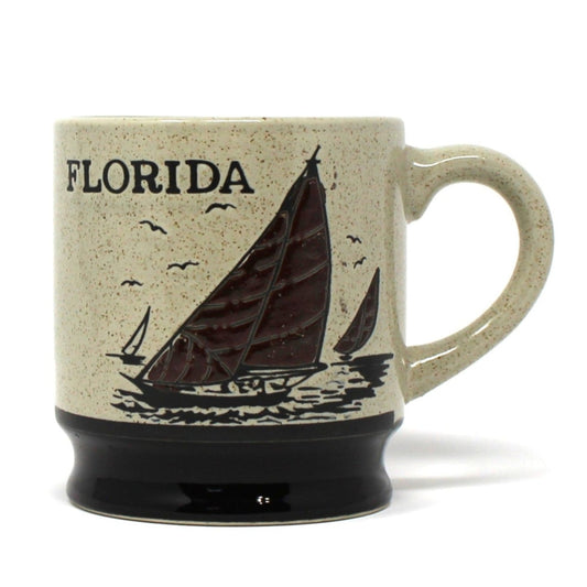 Ceramic mug with 'Florida' and sailboat design on a beige background