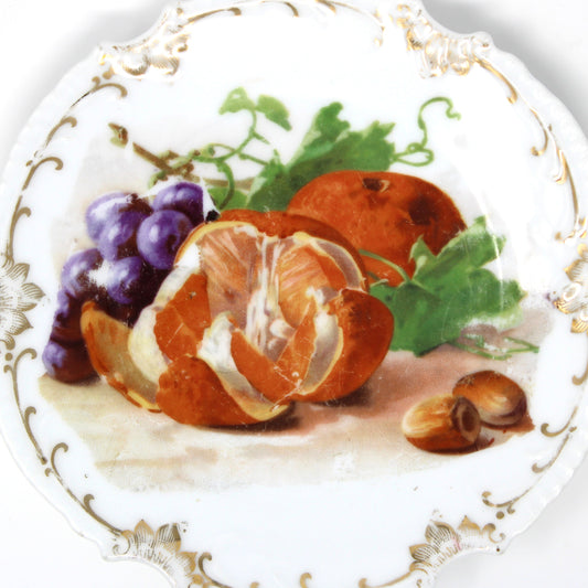 Decorative plate with fruit design on a white background