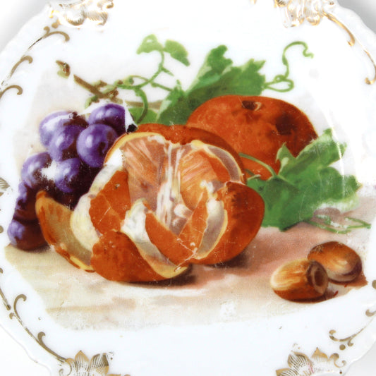 Decorative plate with fruit design on a white background