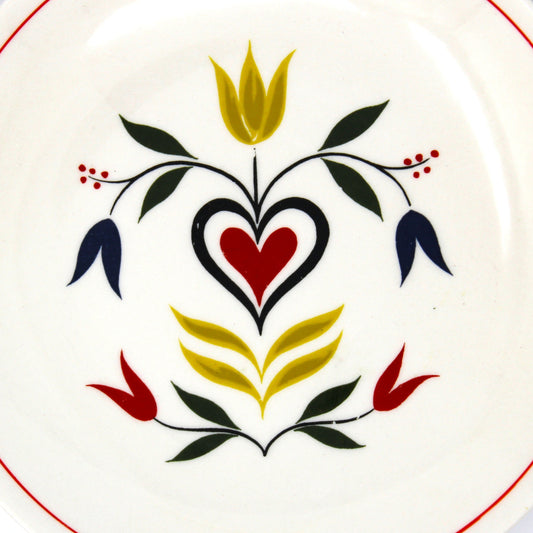 Decorative plate with floral design on an off-white background