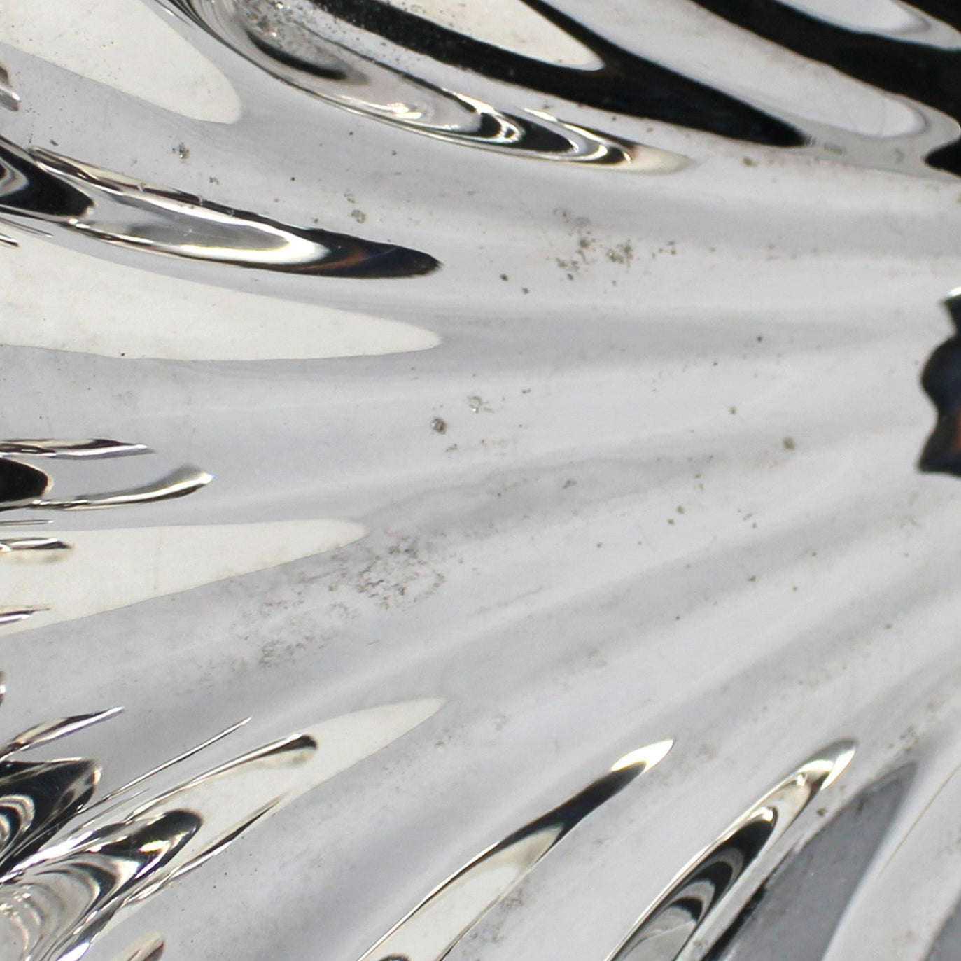 Close up view of silver pitting on vintage serving bowl