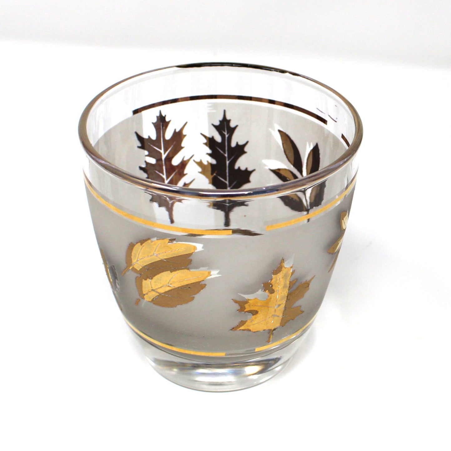 Two glass tumblers with leaf patterns on a white background