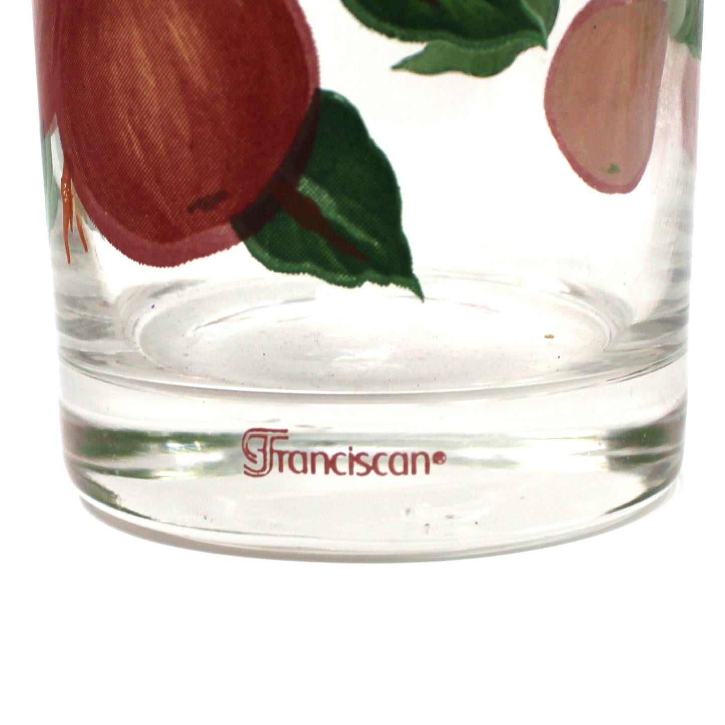 Clear glass tumbler with apple design and 'Franciscan' branding on a white background