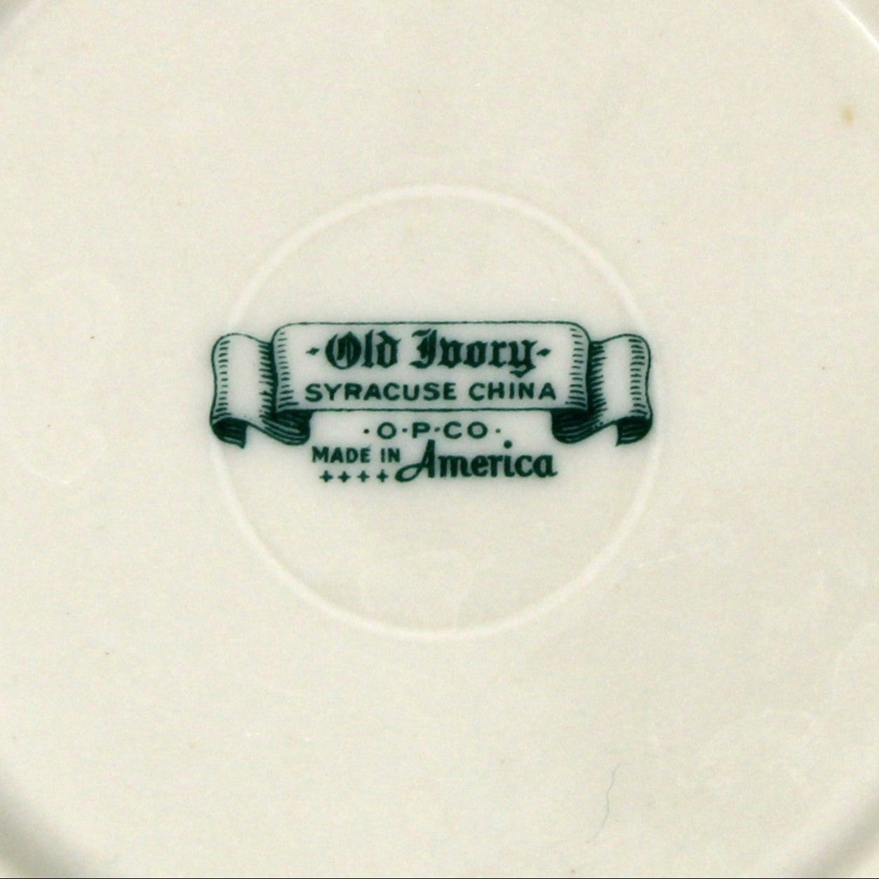 Ceramic small bowl with a visible brand logo, Old Ivory, on a beige background