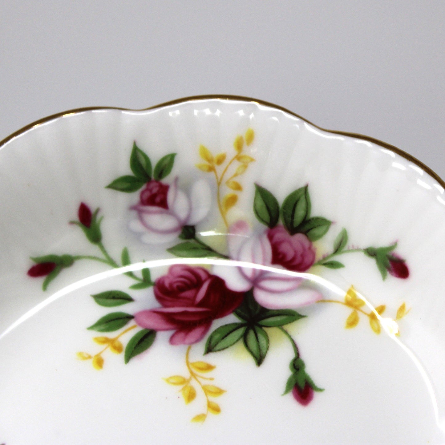 Decorative ceramic plate with floral design on a gray background