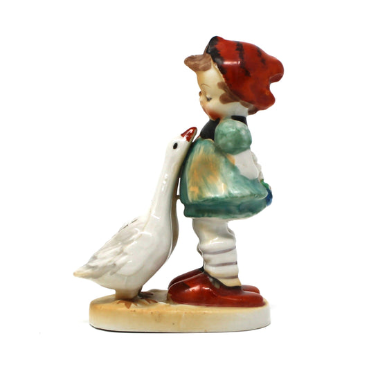 Figurine of a girl with a red hat and two geese, Hummel-Like