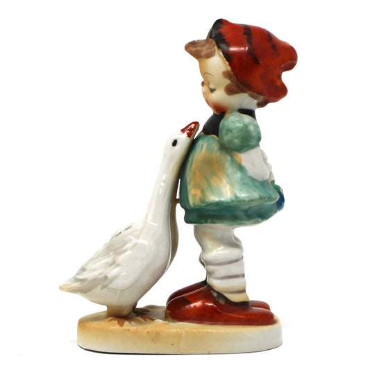 Figurine of a girl with a red hat and two geese, Hummel-Like