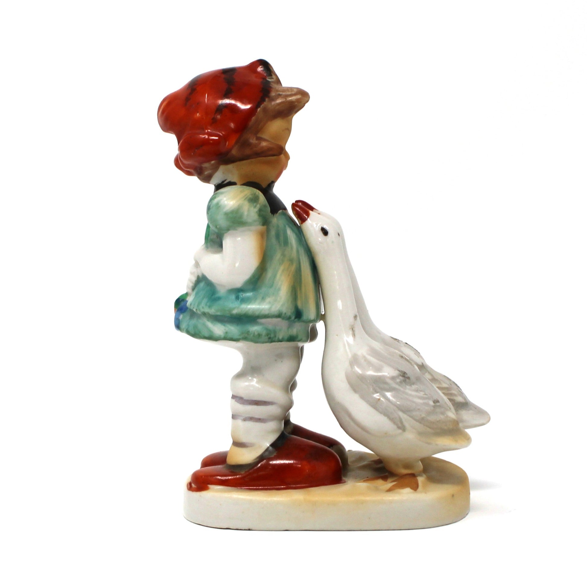 Hummel Like, Porcelain figurine of Goose Girl.  With a red headscarf, blue dress, and two geese.