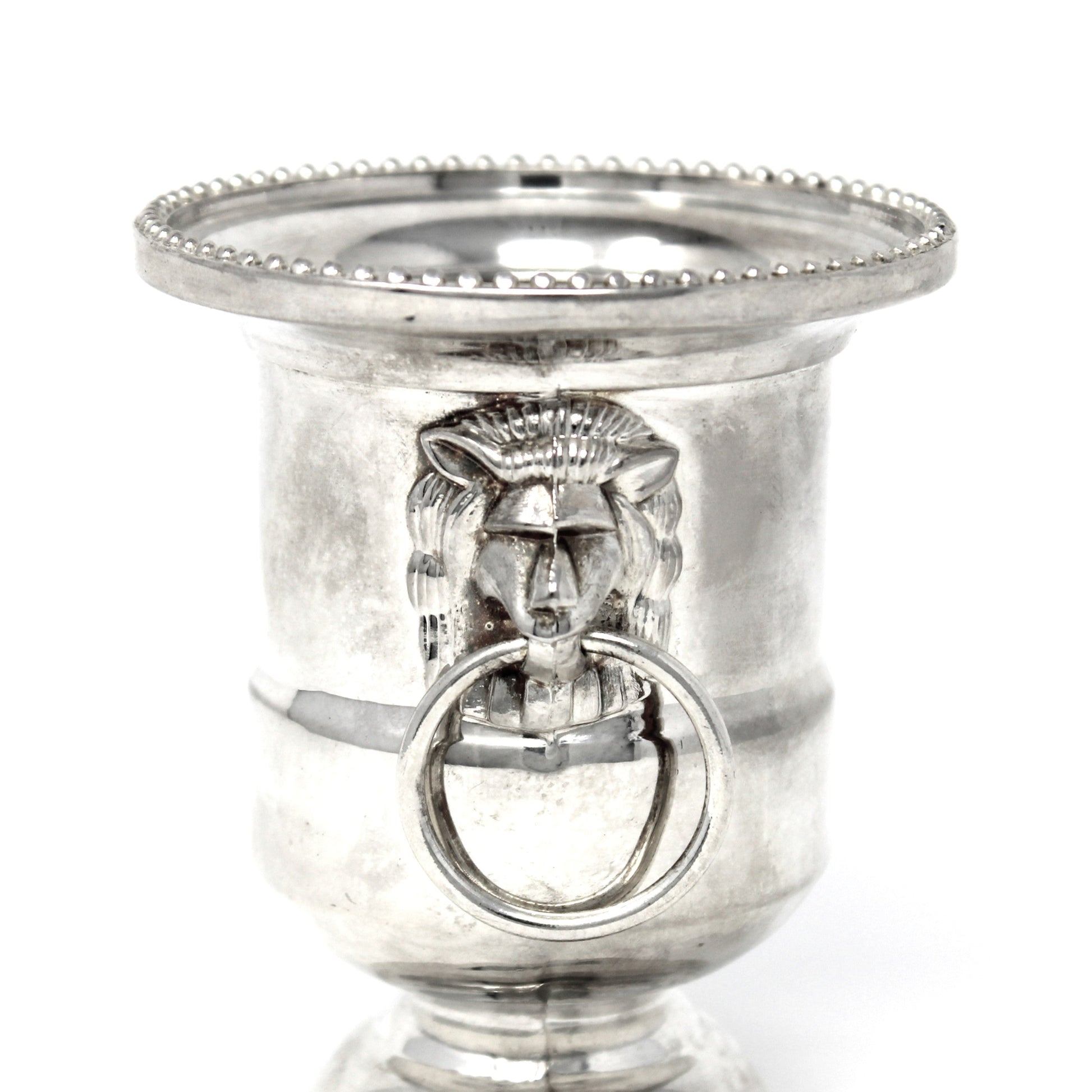 Silver candle holder with decorative design on a white background