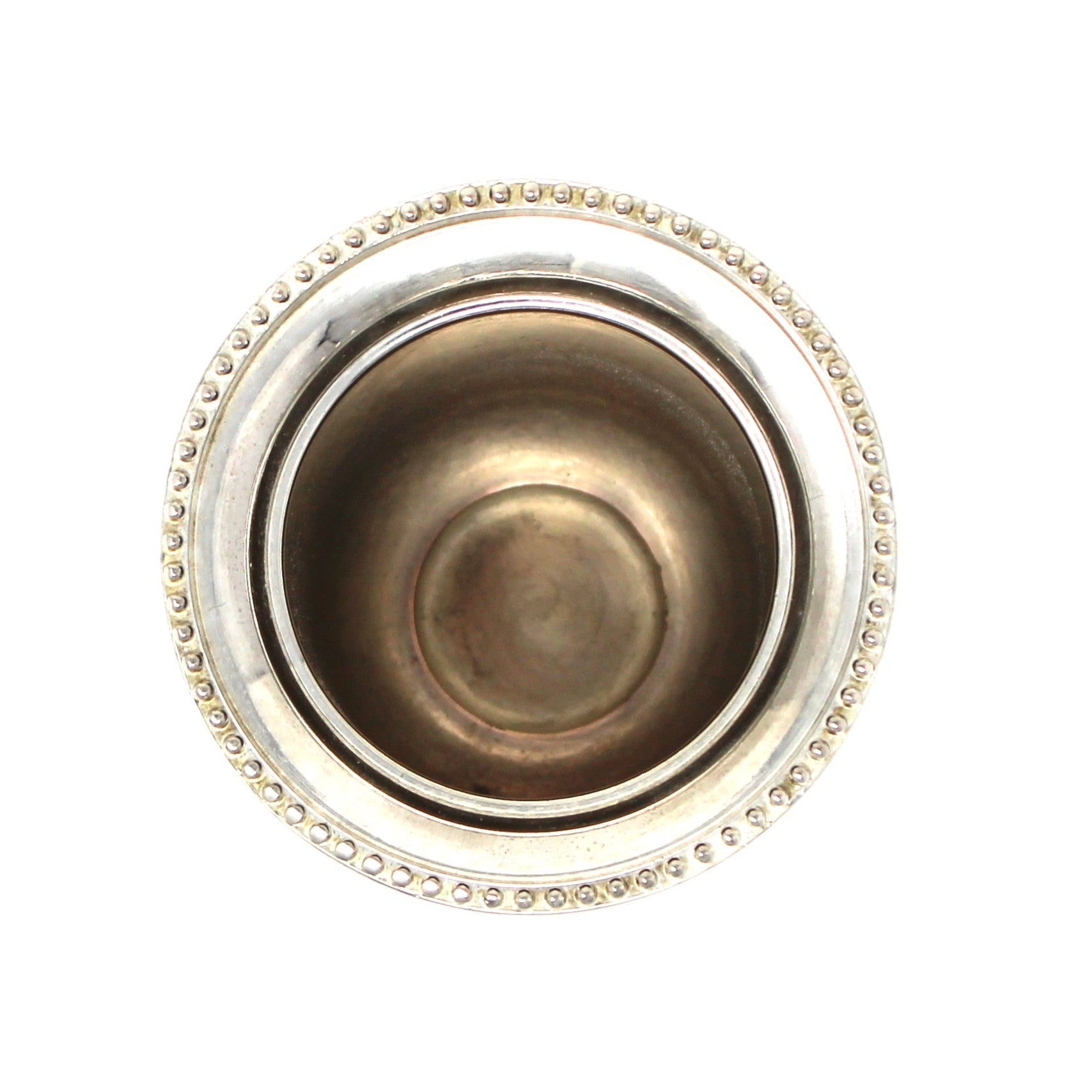 Decorative metal object with intricate design on a white background