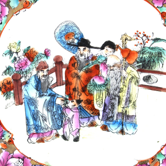 Close up view of decorative Rose Mandarin plate, Famille rose with colorful floral border and traditional family scene