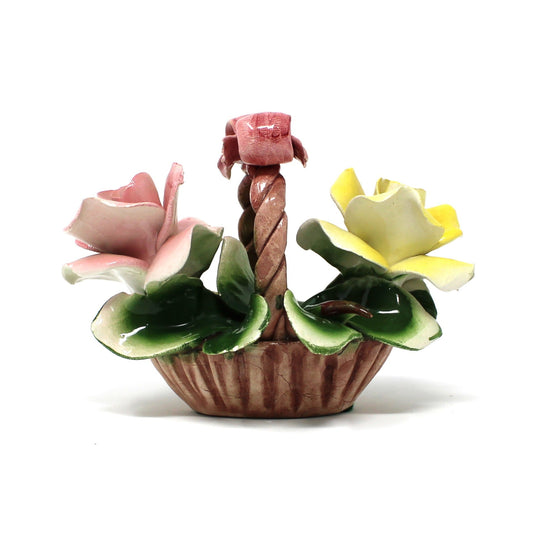 Small ceramic flower basket with flowers on a white background