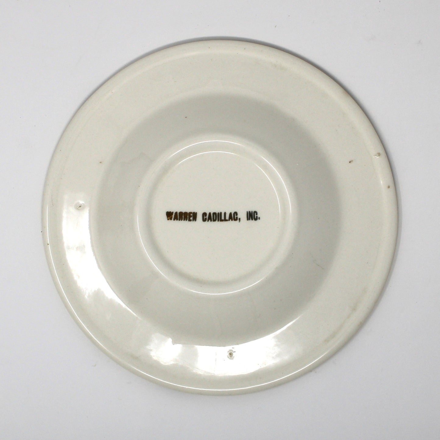Back view of vintage advertising ashtray for Warren Cadillac Inc.