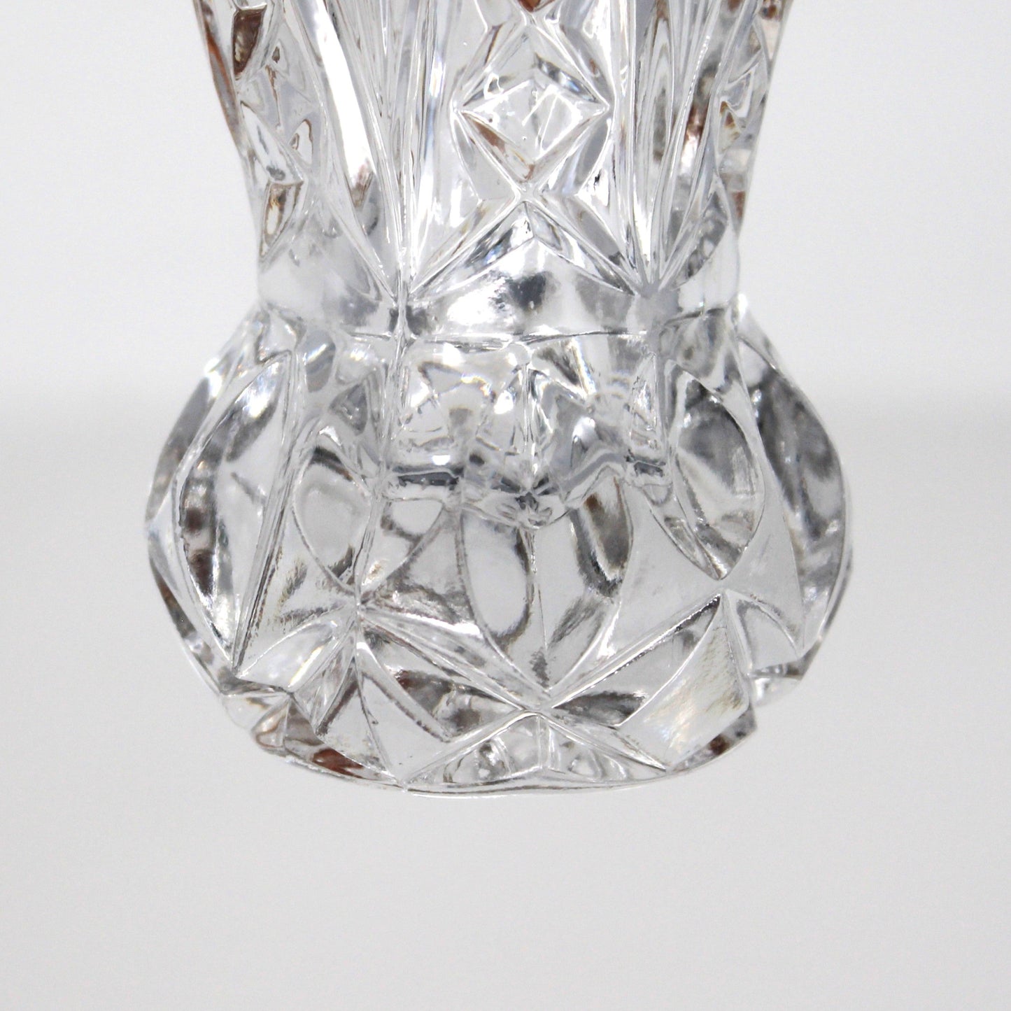 Close up view of bulbous base on vintage, intricately cut crystal, toothpick holder.