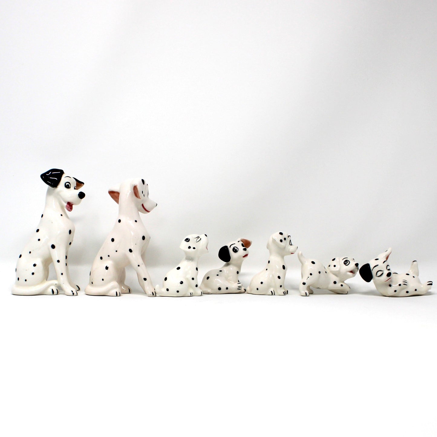 Set of Dalmatian figurines on a white background