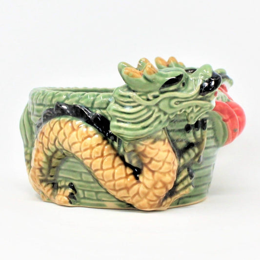 Vintage Majolica-style ceramic planter featuring two dark green Oriental dragons on each side with a woven wicker appearance. The planter is old and has a mark 'SP 08-4' possibly a mold number.