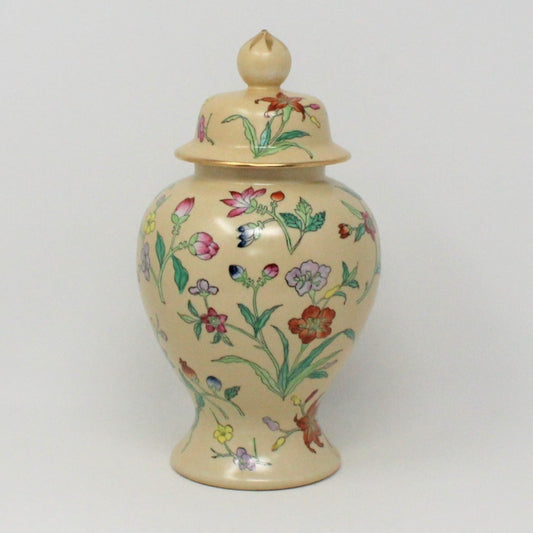 A vintage porcelain ginger jar with hand painted enamel floral design, featuring a variety of colorful flowers on a beige background.