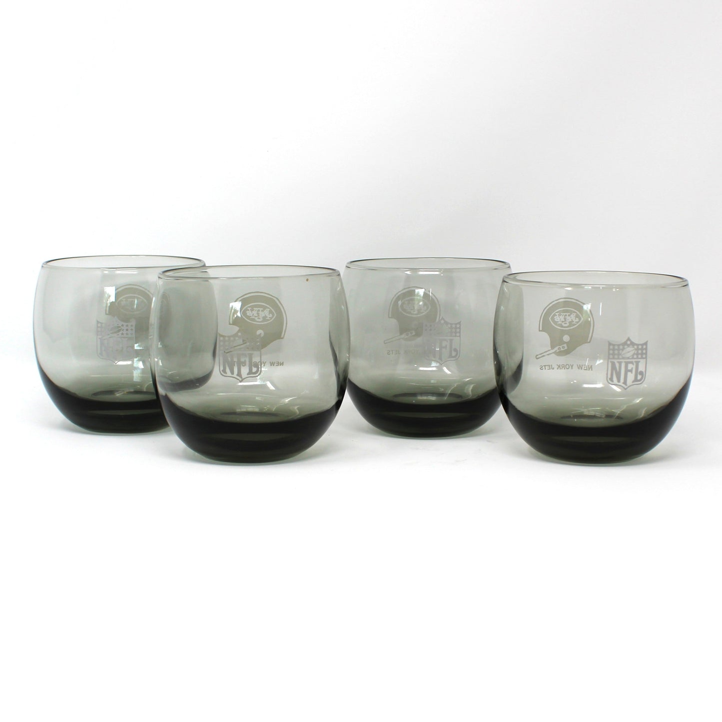 Vintage NFL Football glasses. New York Jets smoked glass roly-poly collectible barware.