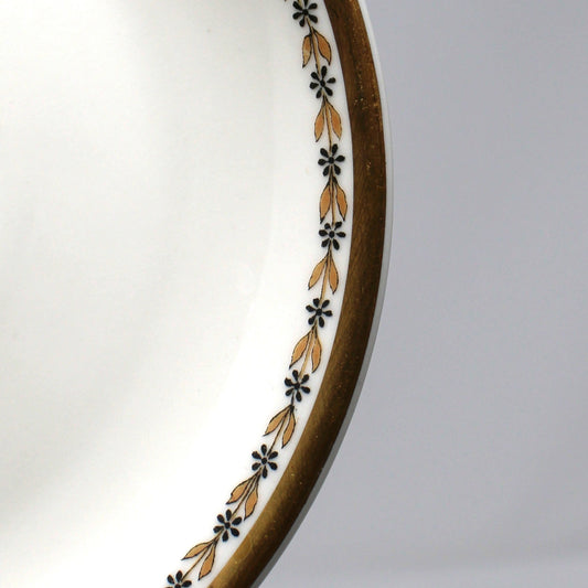 Decorative saucer with floral pattern on a plain background