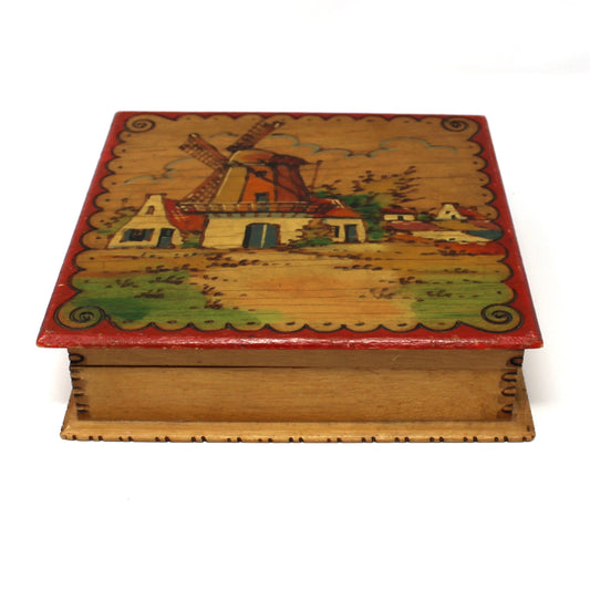 Decorative wooden box with a painted design on a white background