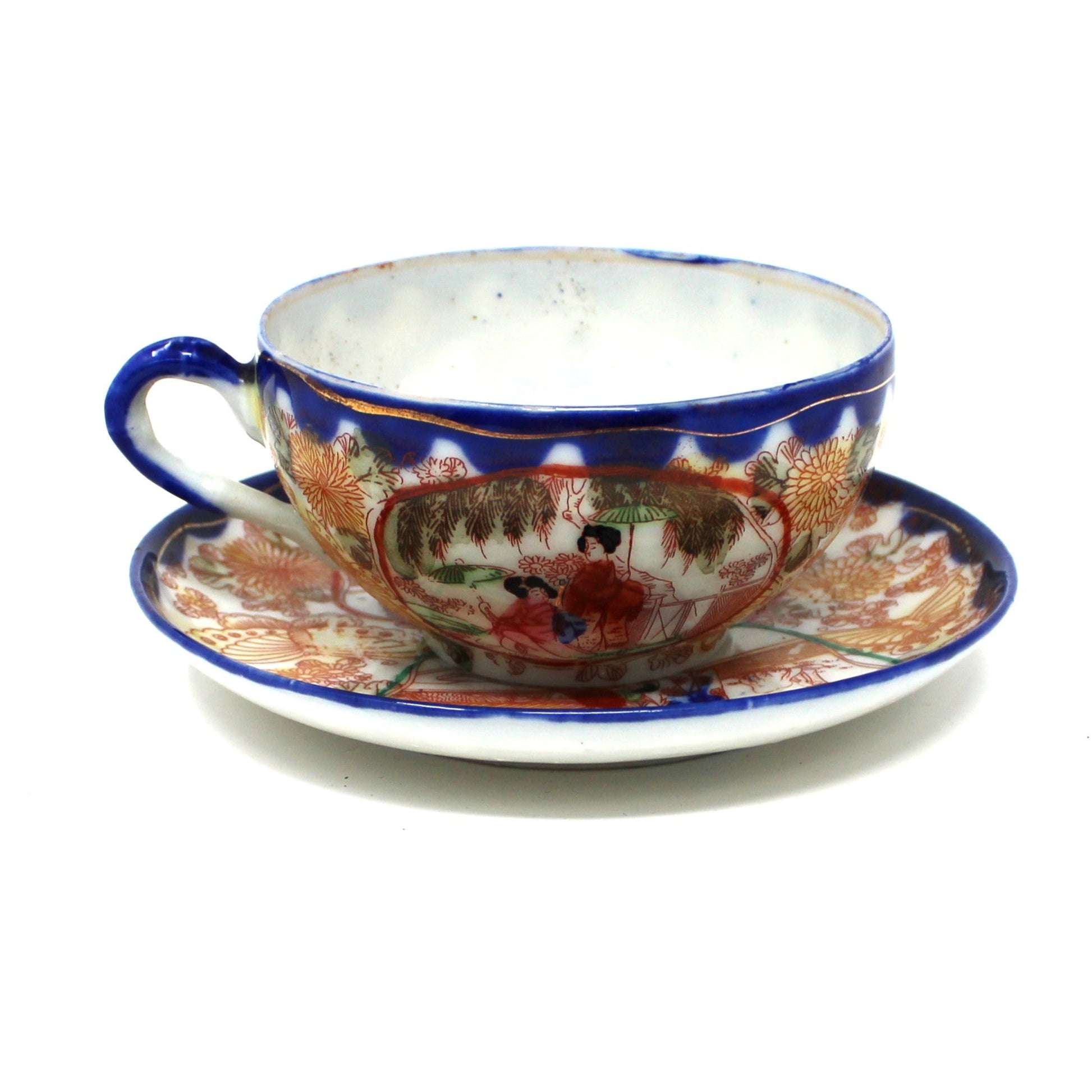 Ceramic cup and saucer with decorative patterns on a white background