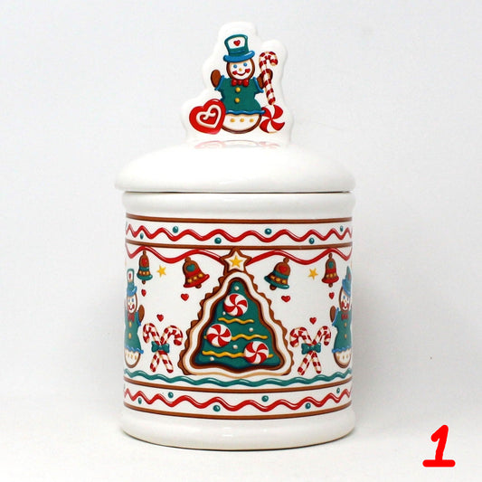A vintage ceramic cookie jar with a Christmas-themed design, featuring gingerbread cookies, candy canes, and a gingerbread house with a snowman on top.  Teleflora Brand