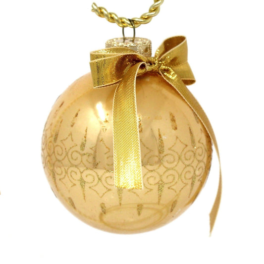 Vintage glass ball ornament.  Gold Christmas ornament with gold glitter, a gold bow and metal cap.