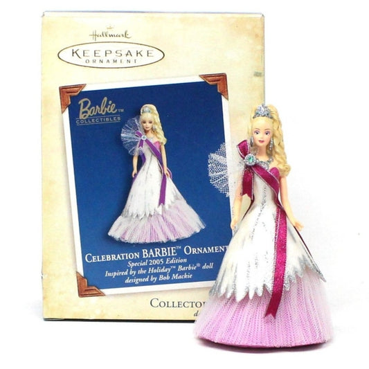 Barbie Christmas ornament in a pink gown with white accents, wearing a sparkling tiara and brooch, displayed with its original packaging. Dated 2005