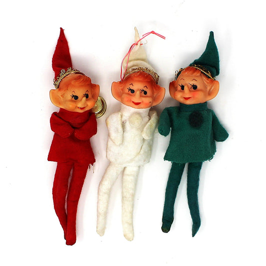 Three vintage pixie elf felt ornaments in red, white, and green, sold separately.