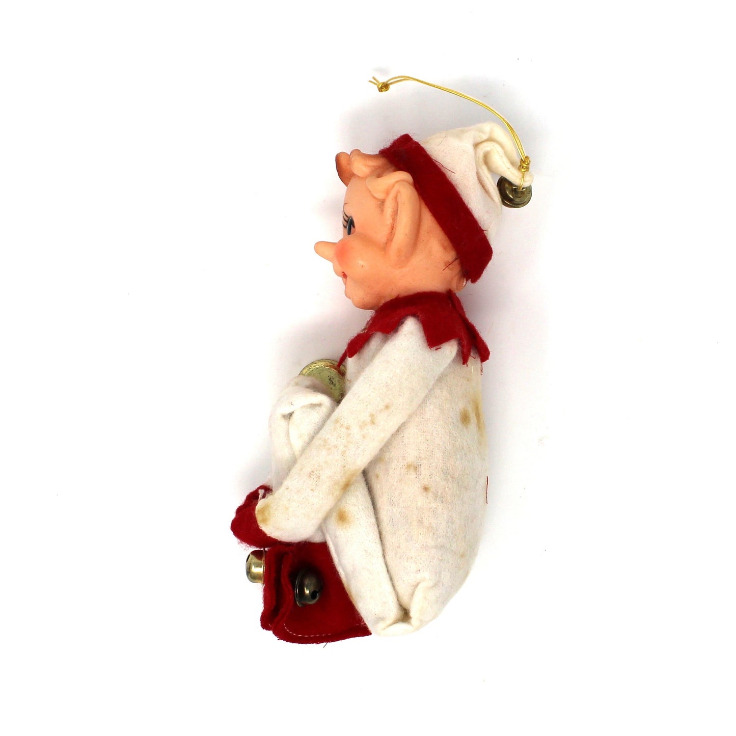 Small figurine of a person wearing a coat and hat on a white background