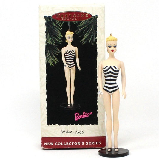 A vintage Hallmark Keepsake ornament featuring the Barbie doll from 1959 in a black and white striped swimsuit, displayed in its original box. Dated 1994