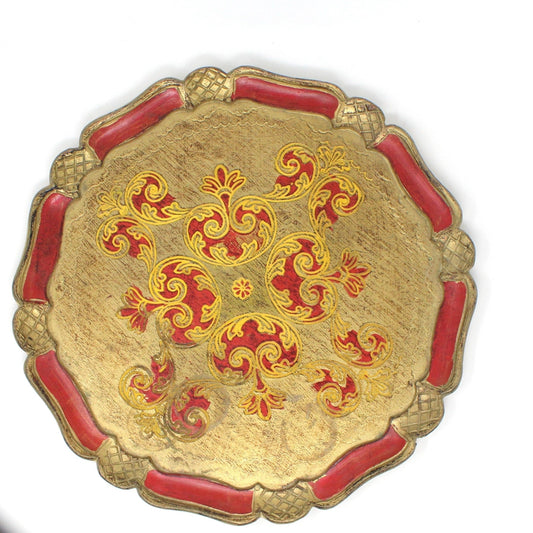 A vintage Italian Florentine hand-carved wood tray with a red and gold color scheme and traditional Renaissance art designs.